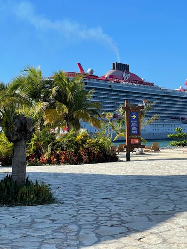 Tropical beach with cruise ship in port
